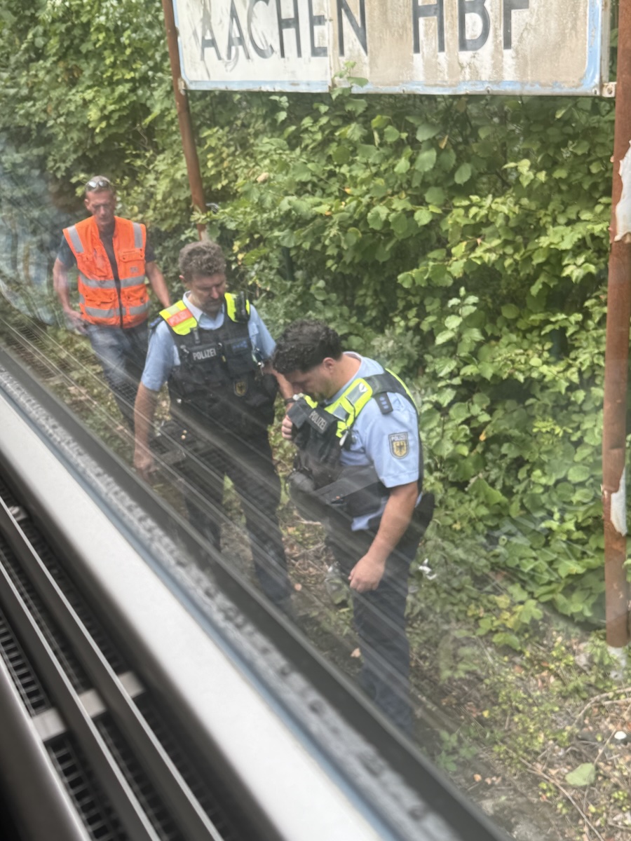 photo: DB workers and German police walking past our car in the sun